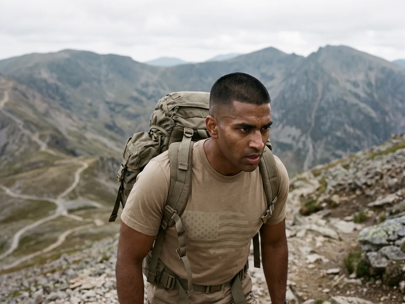 Service member rucking a mountain trail in the subtle tonal flag tee